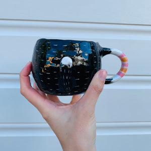 Black and white cat with bubble tea mug