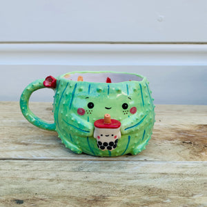 Dark green flowery cactus with bubble tea mug