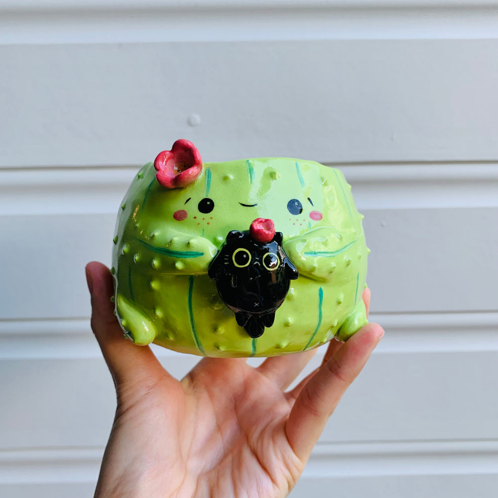 Flowery cactus pot with black cat friend, photo 1 of 6