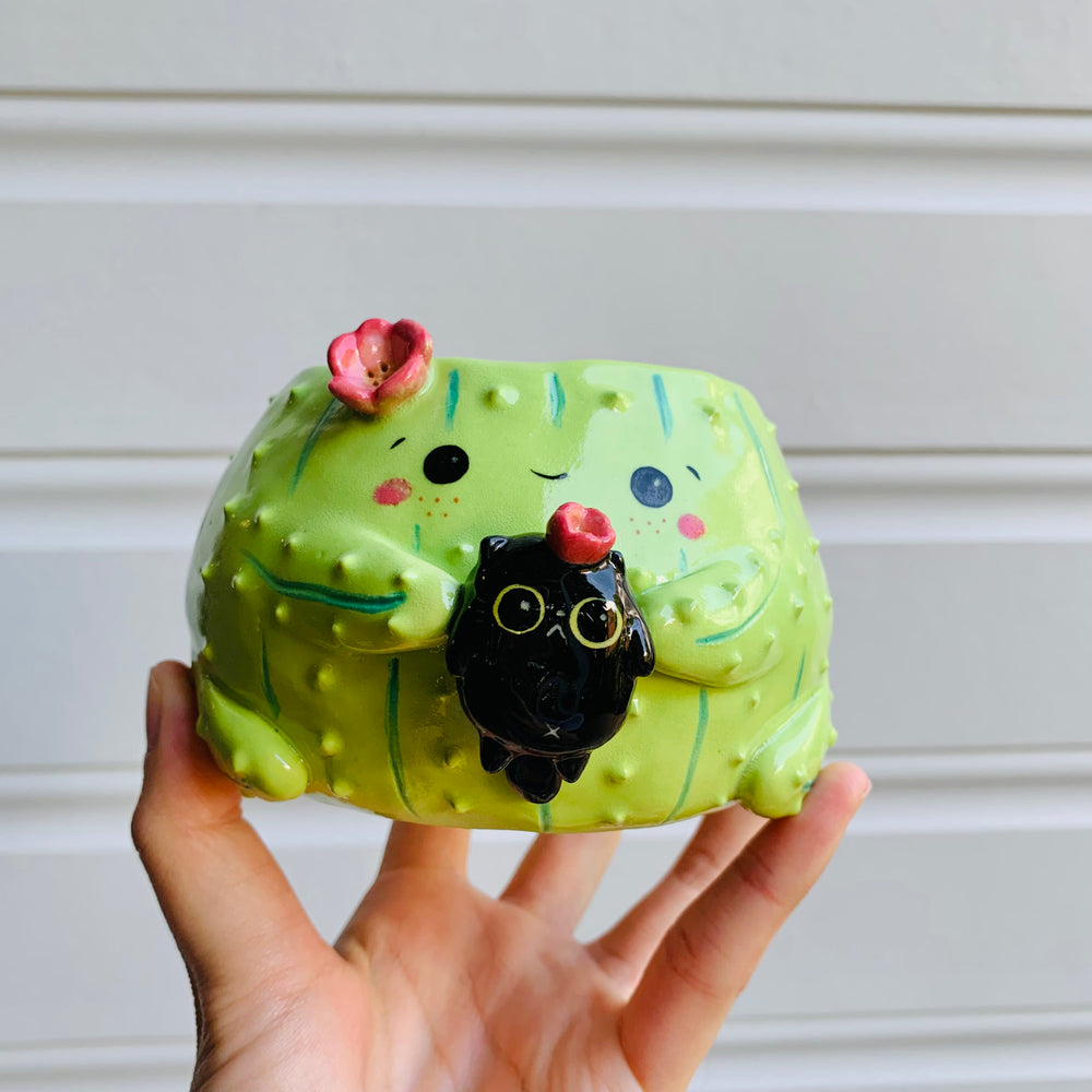 Flowery cactus pot with black cat friend, photo 1 of 6
