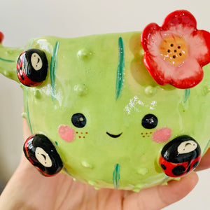 Flowery cactus pot with lady bug friends