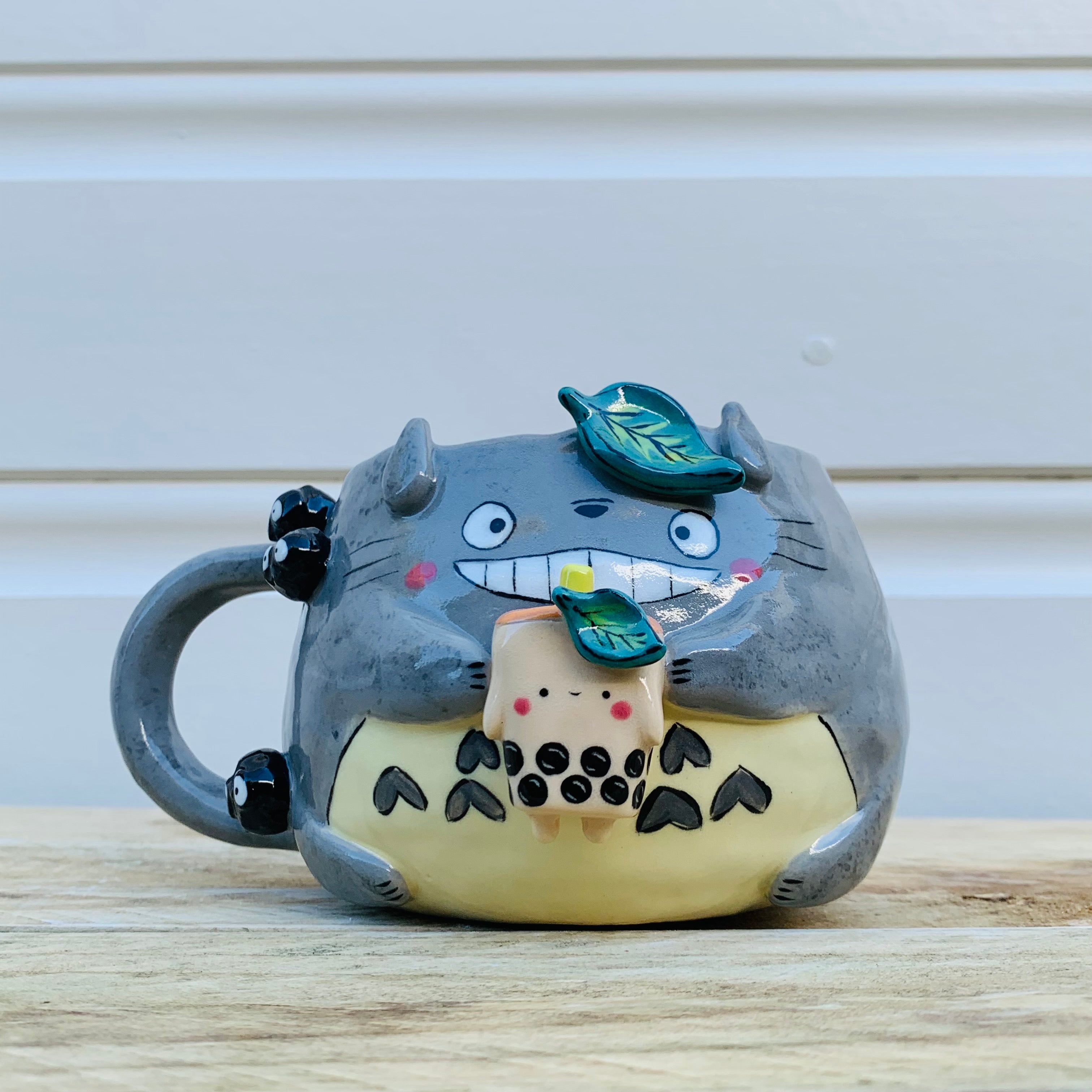 Smiling Totoro with bubble tea mug