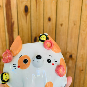 Orange spotty doggo pot with bee friends