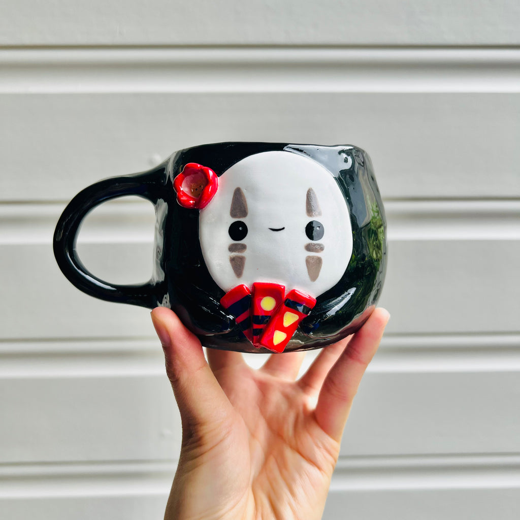 No Face mug with bath tokens