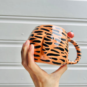 Hat wearing tiger with mandarin friend mug with baby tiger