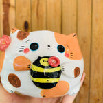 Spotty cat pot with bee friend